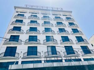 a white building with blue windows and balconies at Foyat Hotel in Addis Ababa