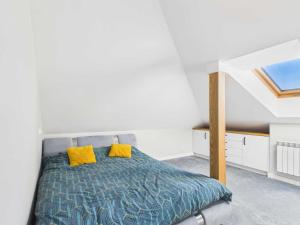 a bedroom with a bed with two yellow pillows at Radość z Marzeń in Suwałki
