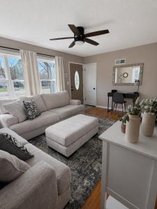 a living room with a couch and a ceiling fan at Serenity Landing in Sioux Falls