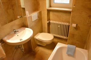 a small bathroom with a sink and a toilet at Pension KaraMia in Fichtelberg
