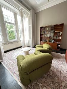 a living room with a couch and two chairs at La Ruche Oostende in Ostend