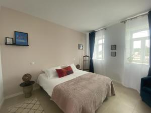 a white bedroom with a bed and a window at Casa Fonte Nova in Covões