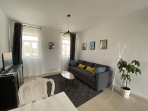 a living room with a couch and a tv at Casa Fonte Nova in Covões