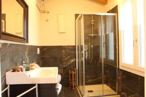 a bathroom with a sink and a shower at Veneto Stay - Pool Loft in Abano Terme +11 photos
