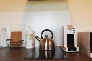 a tea kettle sitting on top of a kitchen counter at Veneto Stay - Pool Loft in Abano Terme