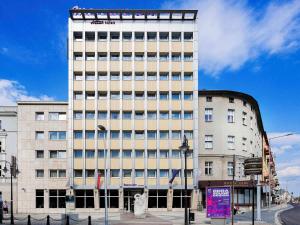 a tall building with a sign on the side of it at Mercure Opole in Opole