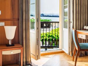 a room with a door open to a balcony at Sofitel Grand Sopot in Sopot