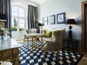 a living room with a table and chairs at Sofitel Grand Sopot in Sopot