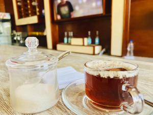 a cup of tea and a glass jar of milk at Foyat Hotel in Addis Ababa