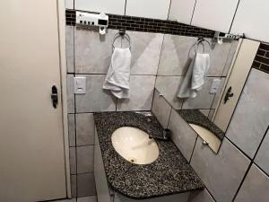 a bathroom with a sink and two mirrors at Smart & Comfort 4 - Ap completo in Campina Grande +37 photos