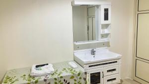 a bathroom with a sink and a mirror at Alsayah in Jazīrat as Sāyah +8 photos