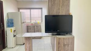 a television sitting on a table in a kitchen at Alsayah in Jazīrat as Sāyah
