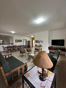 a living room with a table with a lamp on it at Chácara porta do sol in Mairinque