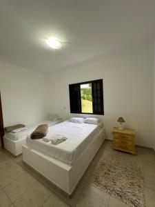 a bedroom with two beds and a window at Chácara porta do sol in Mairinque +51 photos
