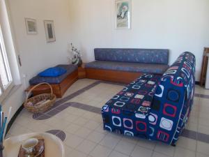 a living room with a couch and a table at Holiday House Torre Di Manfria in Gela