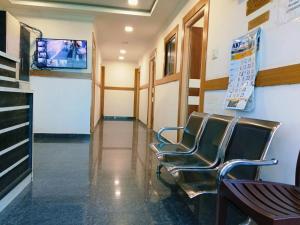 a waiting room at a hospital with chairs at Pacio Residency in Kanchipuram