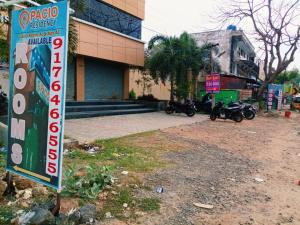 a sign in front of a building with motorcycles parked at Pacio Residency in Kanchipuram +7 photos