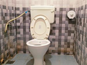a bathroom with a white toilet in a room at Pacio Residency in Kanchipuram