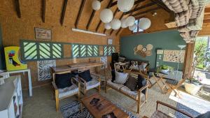 a living room with a table and chairs at Chalets de vacances Castelwood in Biron