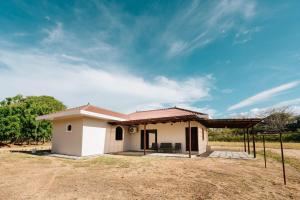 a small white house with a roof at Pedasi, Casa Limon - 2 BD in Purio