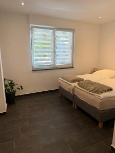a bedroom with two beds and a window at RS home CB 1 in Cottbus +4 photos