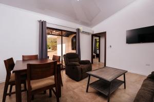 a living room with a table and chairs and a television at Pedasi, Casa Limon - 2 BD in Purio