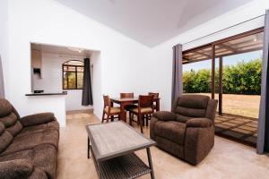 a living room with a couch and chairs and a table at Pedasi, Casa Limon - 2 BD in Purio