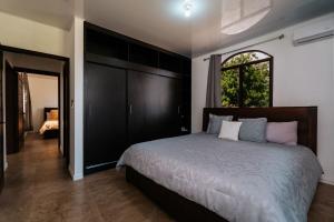 a bedroom with a large bed and a window at Pedasi, Casa Limon - 2 BD in Purio