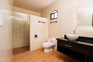 a bathroom with a toilet and a sink and a shower at Pedasi, Casa Limon - 2 BD in Purio +23 photos