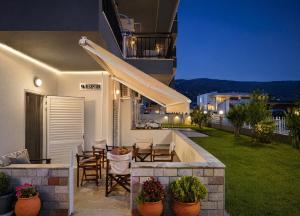 a balcony of a house with a table and chairs at H Stella Apartments & Rooms in Kalamitsi