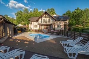 a backyard with a pool and chairs and a house at Casa Bocskai-Vendégház in Sovata