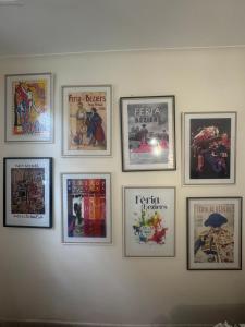 a group of pictures hanging on a wall at Hôtel du Champs de Mars in Béziers
