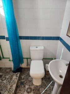 a bathroom with a toilet and a sink at Happy Lodge in Sakumona