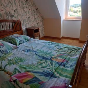a bedroom with a bed with a colorful blanket on it at Le paradis sur mer in Paimpol