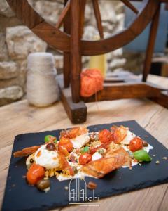 a plate of food on a wooden table at Locanda Ai Archi Di Andreola Monica in Farra di Soligo