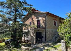 a house with a car parked in front of it at La Poltrona del Diavolo in Montenero