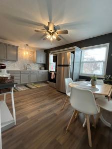 a kitchen with a table and a ceiling fan at Serenity Landing in Sioux Falls