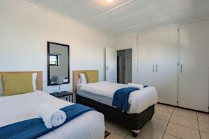 a bedroom with two beds with towels on them at Safi Luxury Self-Catering Suite 8 in East London