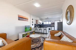 a living room with a couch and a table at Safi Luxury Self-Catering Suite 8 in East London +7 photos
