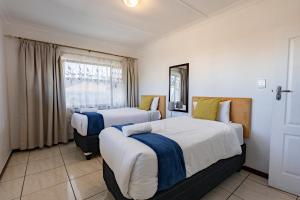 a bedroom with two beds and a window at Safi Luxury Self-Catering Suite 8 in East London