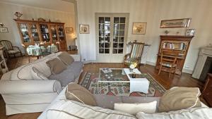 a living room with couches and a coffee table at La terrasse in Limoges +15 photos