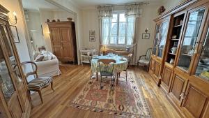 a living room with a table and chairs in it at La terrasse in Limoges