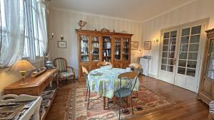 a dining room with a table and a table and chairs at La terrasse in Limoges