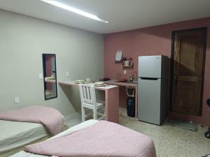 a room with a kitchen with a refrigerator and a table at Jayua Suites & Habitaciones in Córdoba