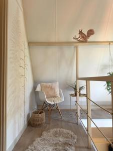 a living room with a ladder and a chair at Wonderwild C79, Dog Friendly in Lanaken