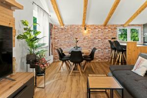 a living room with a brick wall and a table and chairs at Villa Morgan by Rent Istria in Umag +46 photos