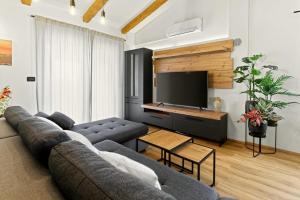 a living room with a couch and a flat screen tv at Villa Morgan by Rent Istria in Umag