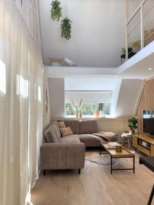 a living room with a couch and a table at Wonderwild C79, Dog Friendly in Lanaken