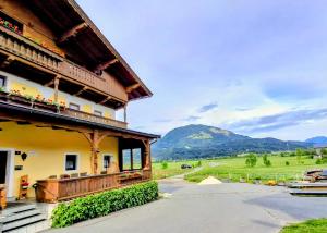 a building with a balcony with a view of a mountain at Lampererhof in Sankt Johann in Tirol