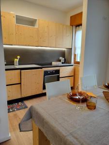 a kitchen with a table with a plate and wine glasses at Casa Silva in Pieve Tesino +9 photos